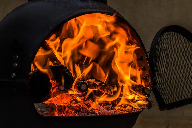 An open chiminea with a fire inside